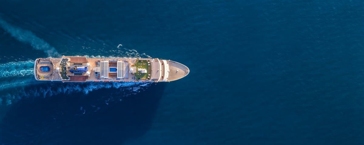 Cruise ship sailing across open blue ocean